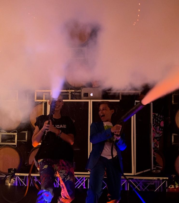 Social event with DJ booth, lighting, and guests on the dance floor