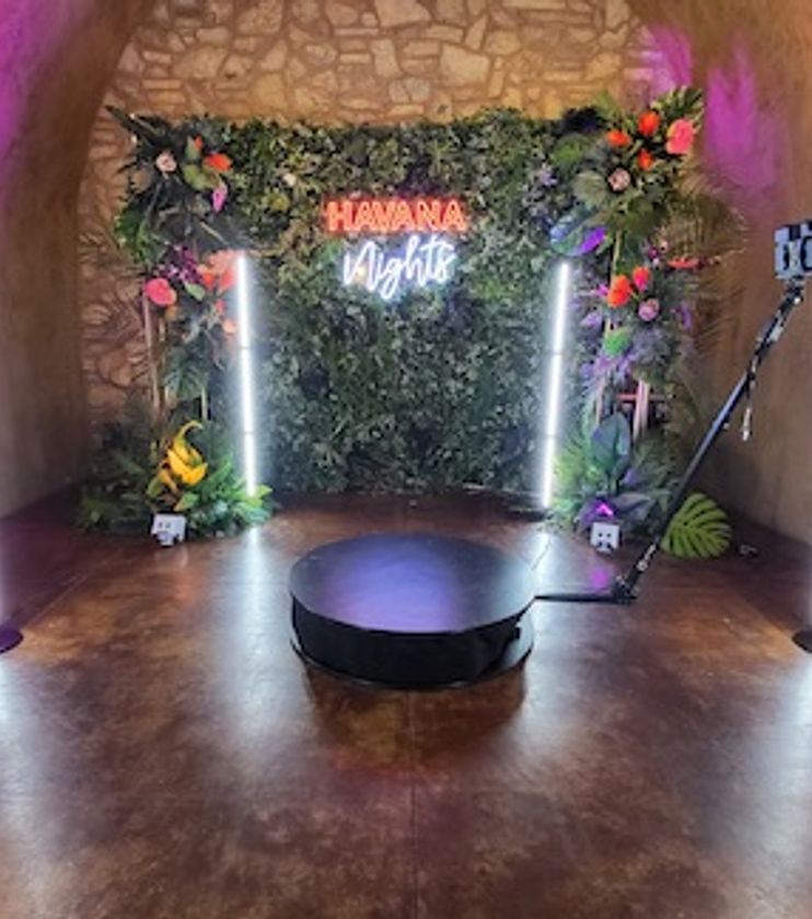 Guests posing on a 360 photo booth platform