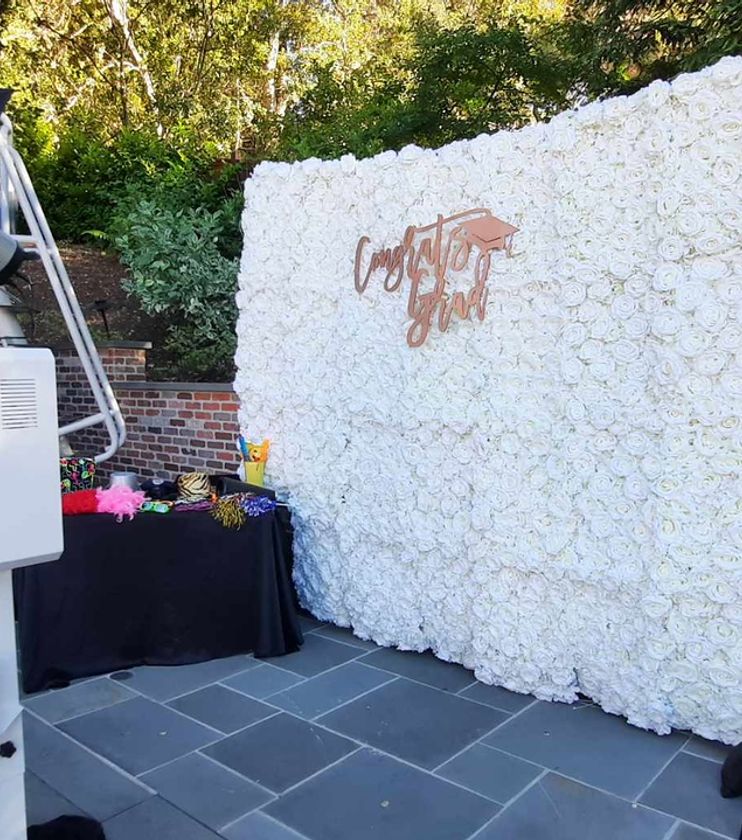 Open style photo booth setup with backdrop