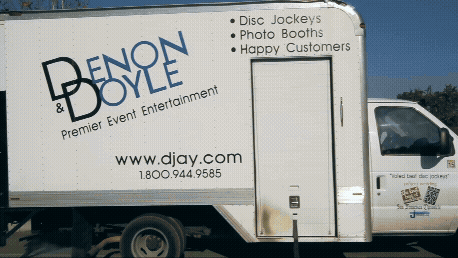 Denon and Doyle branded entertainment truck parked outside an event venue
